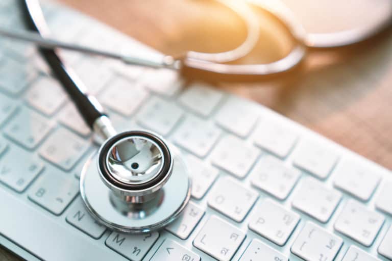 medical stethoscope on keyboard